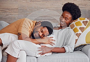 Pregnant, black couple and listening to stomach while excited and happy on lounge couch. Man and woman together talking