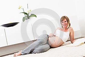 Pregnant blonde woman in her home.