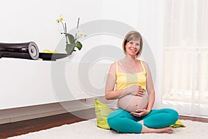 Pregnant blonde woman in her home.