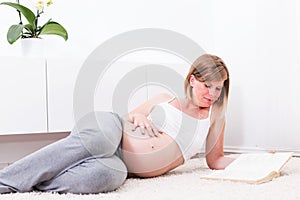 Pregnant blonde woman in her home.