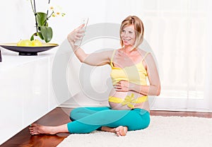 Pregnant blonde woman in her home.