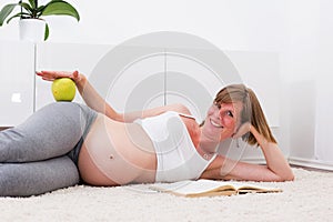 Pregnant blonde woman in the modern home.