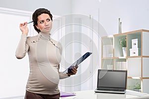 Pregnant business woman in the office