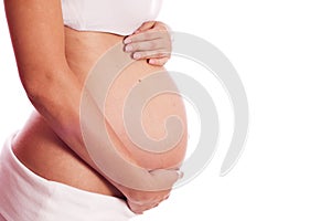 Pregnant Caucasian woman holding her belly