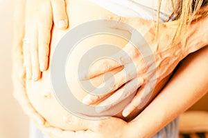 Pregnant couple belly hands. Happy pregnancy woman and husband hugging pregnant belly. Concept of pregnancy, maternity