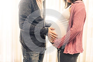 Pregnant couple feels love and relax at home