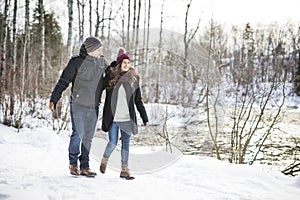 Pregnant couple have fun in winter nature