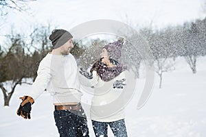 Pregnant couple have fun in winter nature