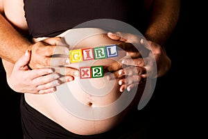 Pregnant couple holding wooden playing blocks