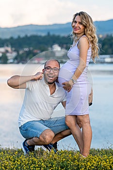 Pregnant couple by lake