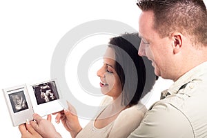 Pregnant couple looking at ultrasound pictures