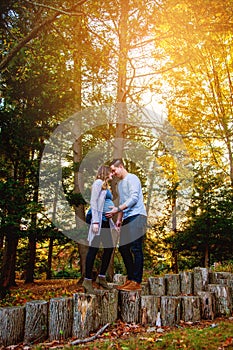 Pregnant couple portrait outdoors in autumn