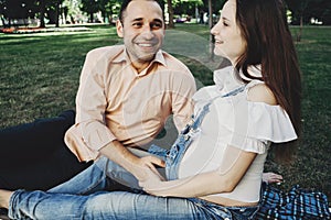 Pregnant couple spending time outdoors chatting