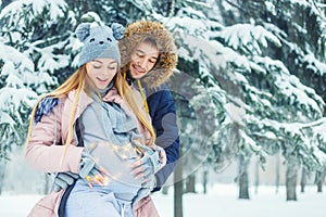 Pregnant couple in winter