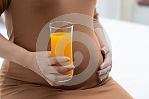 Pregnant are drinking orange juice