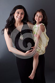 Pregnant East Indian Woman with her Daughter