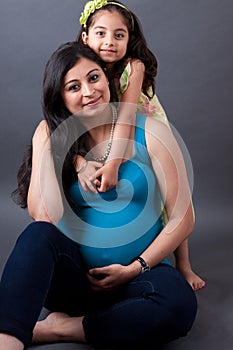 Pregnant East Indian Woman with her Daughter