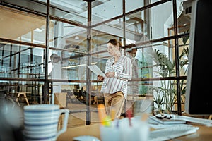 Pregnant employed woman wearing white blouse working hard