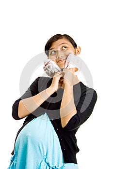 Pregnant ethnic woman with two pairs of baby shoes