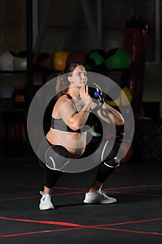 Pregnant female athlete doing goblet squats