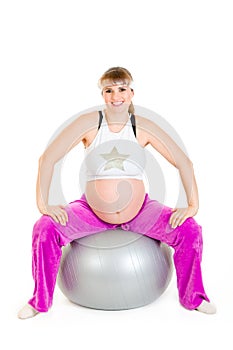 Pregnant female doing exercises on fitness ball