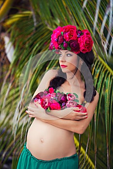 Pregnant girl. Beauty portrait of a beautiful wreath of flowers