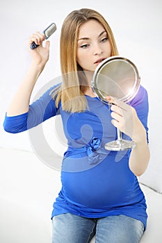 Pregnant girl brushing her hair