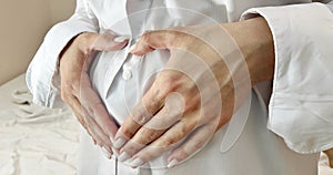 Pregnant girl holds her hand on her belly. International Safe Abortion Day