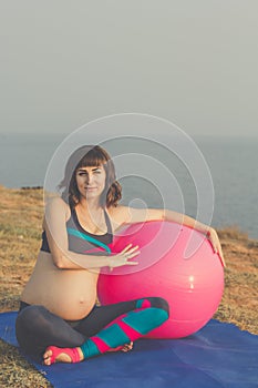 Pregnant girl with pink fitball