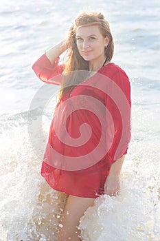 Pregnant girl on the sandy beach