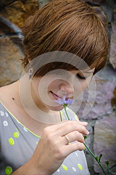 Pregnant girl smelling flower