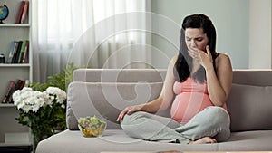 Pregnant girl suffering toxicosis, eating vegetable salad, feeling sickness photo