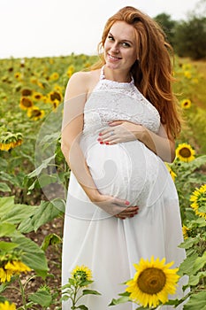 Pregnant girl in sunflowers field