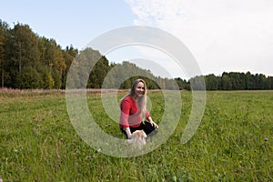 Pregnant girl walking in nature and smiling
