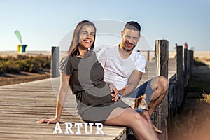 Pregnant happy couple with small dog