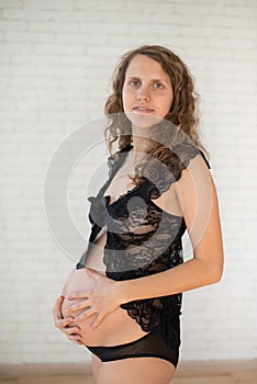 Pregnant Happy smiling Woman sitting on a sofa