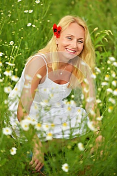 Pregnant happy woman in a flowering poppy field outdoors