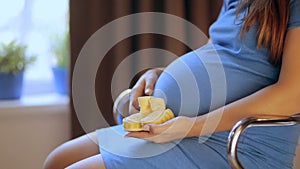 Pregnant happy woman holding baby shoes in her hands. Mom expecting her baby. Pregnant woman belly. Pregnancy. Maternity concept.