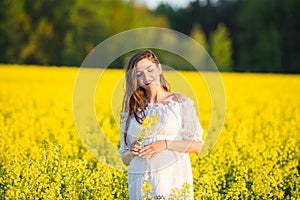Pregnant happy woman touching her belly. Pregnant middle-aged mother portrait caressing her belly and smiling close-up. Healthy
