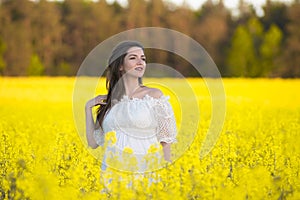 Pregnant happy woman touching her belly. Pregnant middle-aged mother portrait caressing her belly and smiling close-up. Healthy