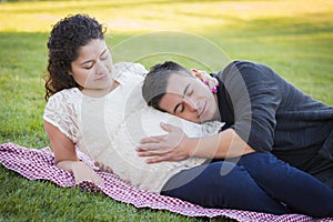 Pregnant Hispanic Couple in The Park Outdoors