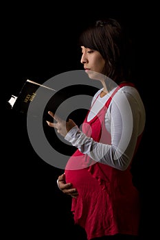 Pregnant Hispanic Woman Reading the Bible