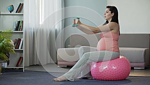 Pregnant lady actively doing fitness, setting example for future mothers