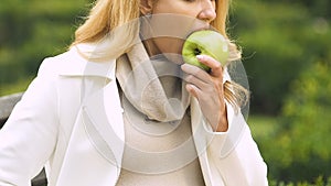 Pregnant lady with big belly feeling sick after biting apple suffering toxicosis