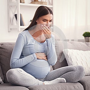 Pregnant Lady Coughing Feeling Sick Touching Mouth Sitting On Sofa