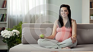 Pregnant lady eating fresh fruits living healthy lifestyle, taking care of child