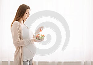 Pregnant lady enjoying fresh natural vegetable salad