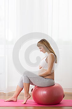 Pregnant lady exercising with ball