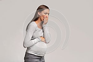 Pregnant Lady Feeling Sick Having Nausea Standing On Gray Background