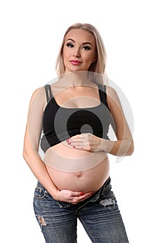 Pregnant lady with hands on her belly. Close up. White background